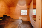 RUDNICK bietet Ankommen. Durchatmen. Wohnfühlen - Holzhausidylle am Steinhuder Meer - 1. Schlafzimmer